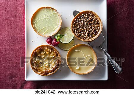 Stock Image - Miniature tarts on tray. Fotosearch