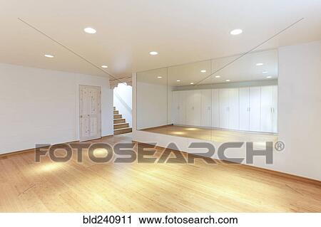 Stock Image - Mirror and cabinets in empty studio. Fotosearch