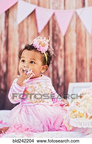 Mixed Race baby eating birthday cake View Large Photo Image Picture - Mixed Race baby eating birthday cake. Fotosearch
