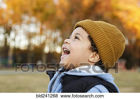 Stock Photo - Mixed Race boy laughing in park. Fotosearch