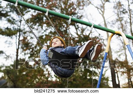 Mixed Race boy on playground swing View Large Photo Image Stock Photography - Mixed Race boy on playground swing. Fotosearch