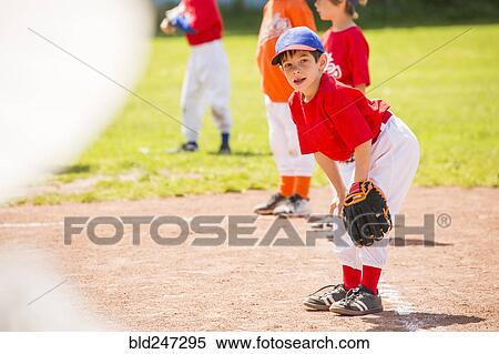 Stock Photography - Mixed Race boy playing baseball. Fotosearch