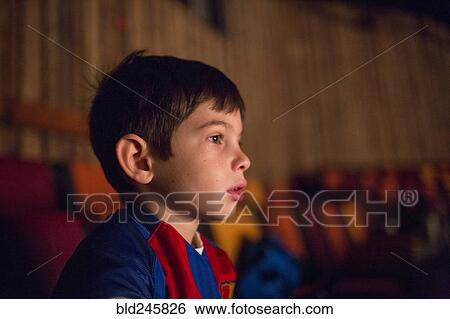 Mixed Race boy watching movie in theater View Large Photo Image Stock Photograph - Mixed Race boy watching movie in theater. Fotosearch