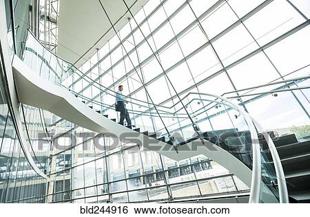 Mixed Race businessman descending staircase View Large Photo Image Stock Photograph - Mixed Race businessman descending staircase. Fotosearch