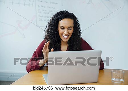Mixed race businesswoman on video conference View Large Photo Image Stock Photograph - Mixed race businesswoman on video conference. Fotosearch