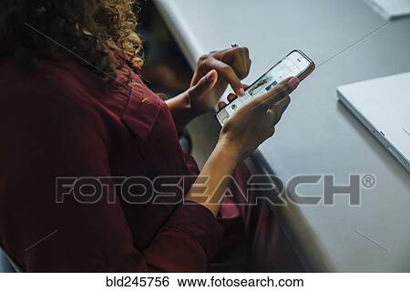 Mixed race businesswoman using cell phone View Large Photo Image Stock Photograph - Mixed race businesswoman using cell phone. Fotosearch