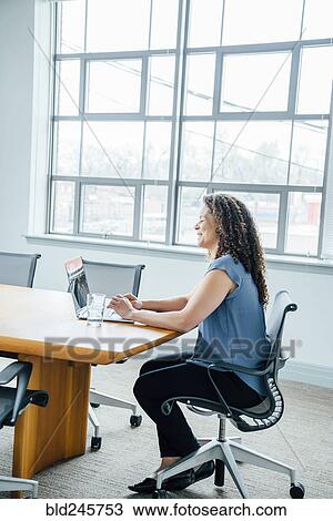 Mixed race businesswoman using laptop View Large Photo Image Stock Image - Mixed race businesswoman using laptop. Fotosearch