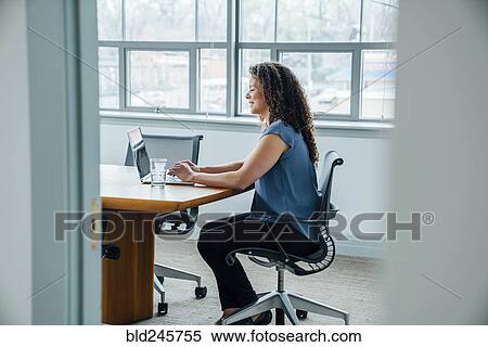 Mixed race businesswoman using laptop View Large Photo Image Stock Photography - Mixed race businesswoman using laptop. Fotosearch