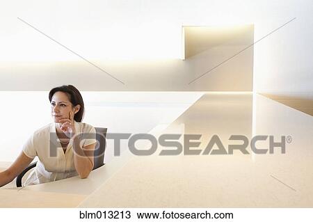 Stock Image - Mixed race businesswoman working in office. Fotosearch
