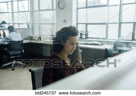 Mixed race businesswoman working in office View Large Photo Image Stock Photo - Mixed race businesswoman working in office. Fotosearch