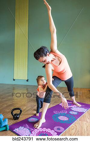 Mixed Race expectant mother practicing yoga and watching daughter View Large Photo Image Stock Image - Mixed Race expectant mother practicing yoga and watching daughter. Fotosearch