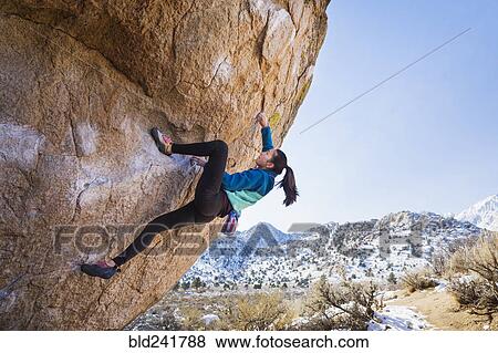 Mixed Race girl climbing rock View Large Photo Image Stock Photo - Mixed Race girl climbing rock. Fotosearch