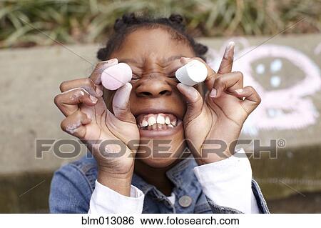 Stock Photograph - Mixed race girl playing with chalk. Fotosearch