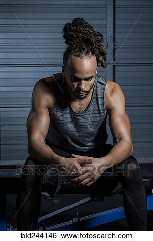 Mixed Race man resting in gymnasium View Large Photo Image Stock Photograph - Mixed Race man resting in gymnasium. Fotosearch