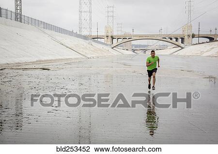 Mixed Race man running in canal View Large Photo Image Stock Image - Mixed Race man running in canal. Fotosearch