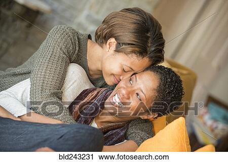 Mixed Race mother and daughter hugging View Large Photo Image Stock Image - Mixed Race mother and daughter hugging. Fotosearch