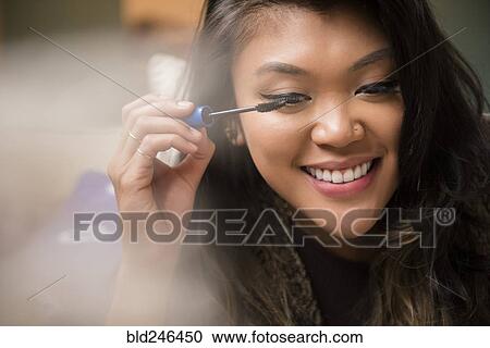 Mixed Race woman applying mascara View Large Photo Image Stock Image - Mixed Race woman applying mascara. Fotosearch