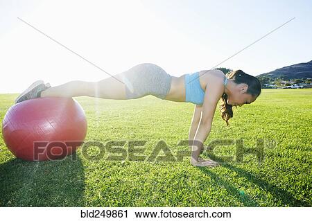 Mixed Race woman balancing on fitness ball doing push-ups View Large Photo Image Stock Image - Mixed Race woman balancing on fitness ball doing push-ups. Fotosearch