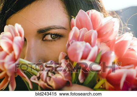 Mixed Race woman hiding face behind flowers View Large Photo Image Stock Photography - Mixed Race woman hiding face behind flowers. Fotosearch