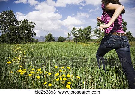 Mixed Race woman running in field View Large Photo Image Stock Image - Mixed Race woman running in field. Fotosearch