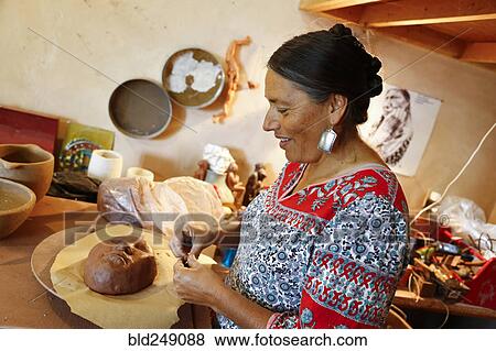 Mixed race woman shaping clay mask in art studio View Large Photo Image Stock Photo - Mixed race woman shaping clay mask in art studio. Fotosearch