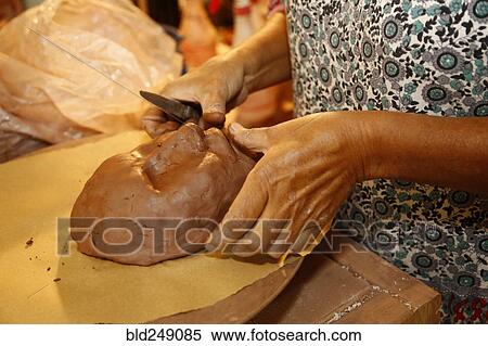 Mixed race woman shaping clay mask in art studio View Large Photo Image Stock Photography - Mixed race woman shaping clay mask in art studio. Fotosearch