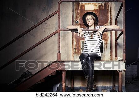 Mixed race woman sitting on staircase outside door View Large Photo Image Picture - Mixed race woman sitting on staircase outside door. Fotosearch