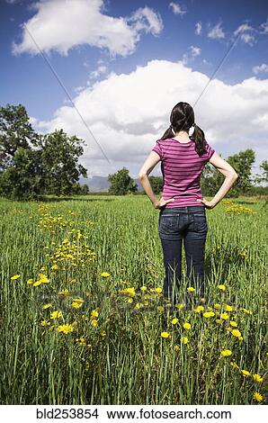 Mixed Race woman standing in field View Large Photo Image Picture - Mixed Race woman standing in field. Fotosearch