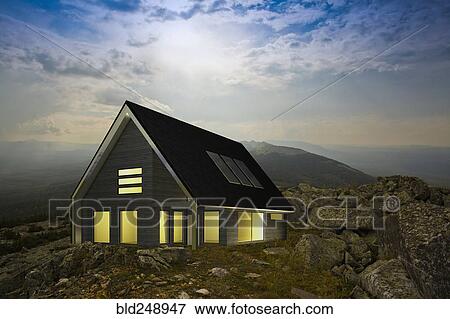 Stock Photo - Modern house in remote rocky landscape. Fotosearch