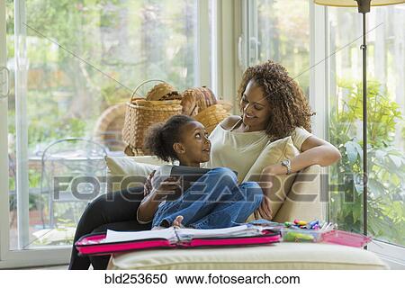 Stock Image - Mother and daughter using digital tablet. Fotosearch