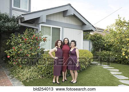 Mother and daughters posing near house View Large Photo Image Stock Image - Mother and daughters posing near house. Fotosearch