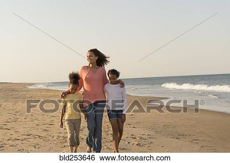 Mother and daughters walking on beach View Large Photo Image Stock Photograph - Mother and daughters walking on beach. Fotosearch