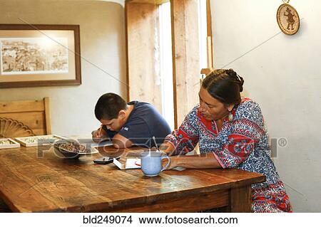 Picture - Mother and son writing at table. Fotosearch
