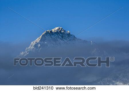 Mountain peak above clouds View Large Photo Image Stock Image - Mountain peak above clouds. Fotosearch