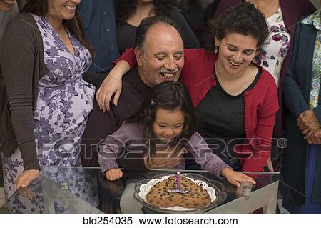 Stock Photography - Multi-generation family celebrating birthday of older man. Fotosearch