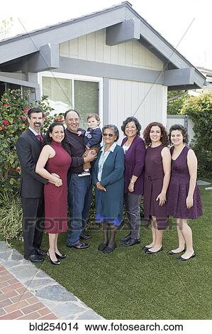 Picture - Multi-generation family posing near house. Fotosearch