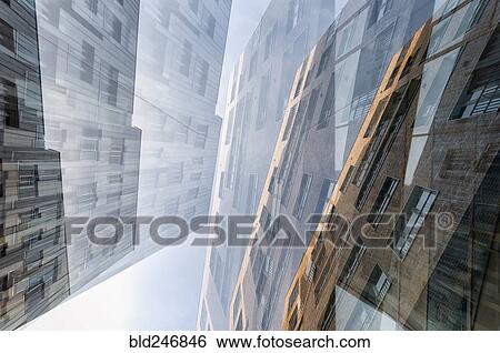 Stock Photograph - Multiple exposure of highrises under cloudy sky. Fotosearch