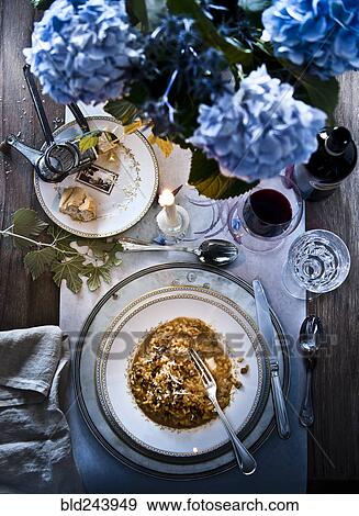 Stock Photo - Mushroom risotto meal with wine. Fotosearch