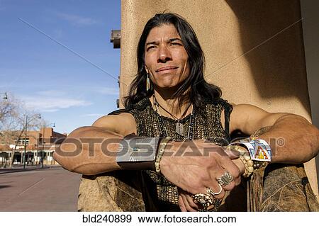 Native American man sitting against post View Large Photo Image Stock Photo - Native American man sitting against post. Fotosearch