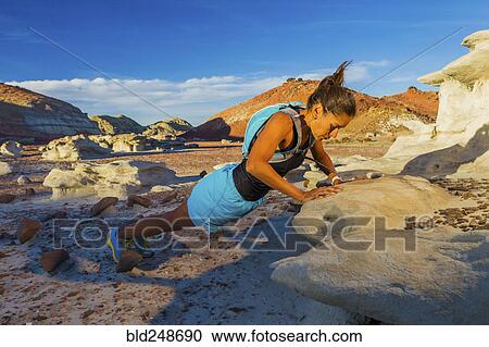 Native American woman doing push-up on rock in desert View Large Photo Image Stock Image - Native American woman doing push-up on rock in desert. Fotosearch