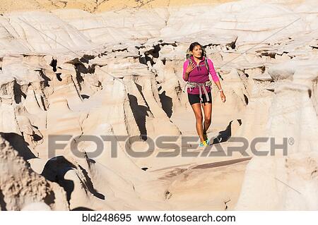 Stock Photography - Native American woman hiking in desert. Fotosearch