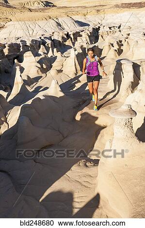Stock Image - Native American woman running in desert. Fotosearch