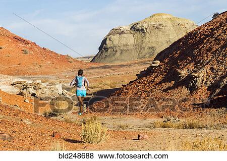 Stock Photo - Native American woman running in desert. Fotosearch
