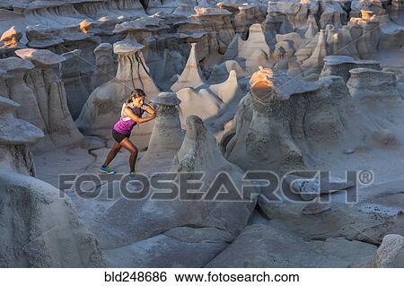 Stock Photograph - Native American woman stretching in desert. Fotosearch