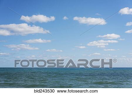 Stock Image - Ocean seascape under blue sky. Fotosearch
