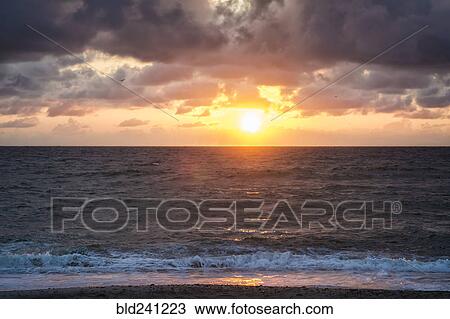 Ocean waves on beach at sunset View Large Photo Image Stock Image - Ocean waves on beach at sunset. Fotosearch