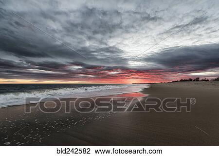 Ocean waves on beach at sunset View Large Photo Image Stock Image - Ocean waves on beach at sunset. Fotosearch