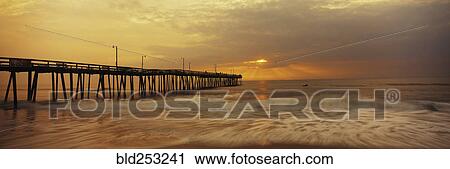 Ocean waves under pier at sunset View Large Photo Image Stock Image - Ocean waves under pier at sunset. Fotosearch
