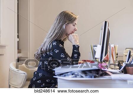 Picture - Older Caucasian businesswoman using a computer. Fotosearch