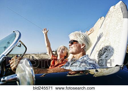 Older Caucasian couple in convertible car with surfboards on beach View Large Photo Image Stock Image - Older Caucasian couple in convertible car with surfboards on beach. Fotosearch